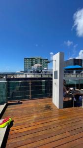 a wooden deck with a view of a city at Israel flat tambau 106 in João Pessoa