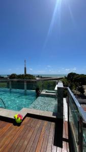 a swimming pool on top of a wooden deck at Israel flat tambau 106 in João Pessoa