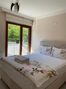 a bedroom with a large bed with a window at Özyurt Villa in Araklı