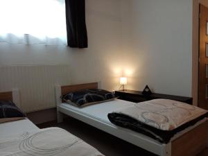 Postel nebo postele na pokoji v ubytování Apartmán Nepomuk