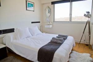 a bedroom with a white bed with towels on it at Perfect Modern High Floor apt with all Paris View in Paris