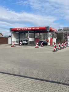 a car gas station with a red roof at B-HAUSE zárt parkolóval és jacuzzival in Debrecen