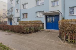 a blue building with a blue door in front at 2 bedroom Apartment Zamiejska by Rent like home in Gdańsk