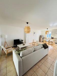 a living room with a couch and a table and chairs at Appart*Parking*Résidence Piscine*Sarlat in Sarlat-la-Canéda +5 photos