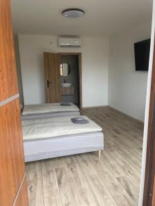 A bed or beds in a room at Penzion Farmer Kapušany