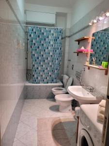 a bathroom with a toilet and a sink and a shower at FAMILY in San Giuliano Milanese +10 photos