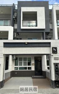a large building with a door in front of it at Ming House in Taitung City