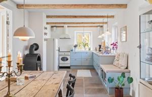 a kitchen with a wooden table and a dining room at 3 Bedroom Amazing Home In Sams in Kolby Kås
