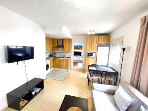 a small living room with a couch and a table at Fray Isidoro Apartment in Seville