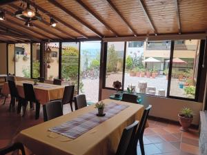 a restaurant with tables and chairs and a large window at Hotel Villa Sofia in Nobsa +37 photos