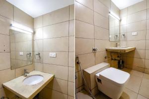 a bathroom with a toilet and a sink at FabHotel The Oasis in Bhopal