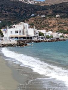 a beach with white buildings and the ocean at Lefakis cottage in Órmos