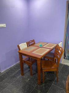 a wooden table with two chairs at Om Sai Nilayam Guest house in Tirupati