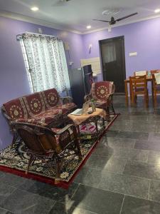 a living room with a couch and chairs and a table at Om Sai Nilayam Guest house in Tirupati