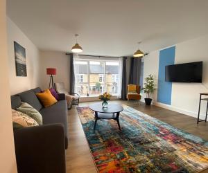 a living room with a couch and a table at Cambridge Stays Riverside 2BR Flat-Walk to Centre-Parking-Balcony in Cambridge