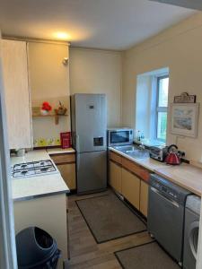 a kitchen with a stainless steel refrigerator and a window at Central 1st Class in Quiet Location in Galashiels