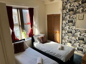 a small bedroom with two beds and a window at Central 1st Class in Quiet Location in Galashiels
