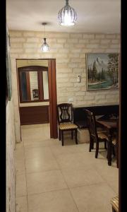 a living room with a table and chairs and a dining room at apartments furnished for rent in Amman Jordan in Amman