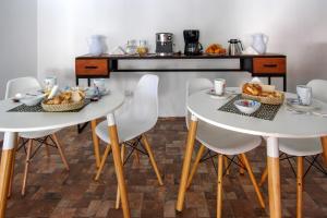dos mesas blancas con cestas de pan. en Las Palmas en Mercedes