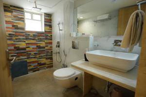 a bathroom with a sink and a toilet and a shower at Hotel 6 Seasons, Koregoan Park, Pune in Pune