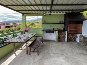 a patio with a wooden table and a stove at Buenavista in Breña Alta