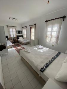 a bedroom with a large bed in a room at Sevgi Hotel Kalkan in Kalkan
