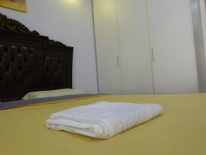 a bed with two white towels on it at Beautiful Cool Room for Coupls & faimly in Dubai