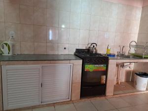 a kitchen with a stove and a sink in it at Las Moras in Maimará