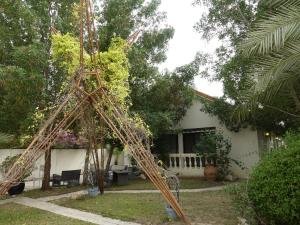 a wooden frame in the yard of a house at Beautiful Cool Room for Coupls & faimly in Dubai