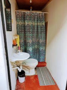 a small bathroom with a sink and a toilet at La Merced in Antigua Guatemala