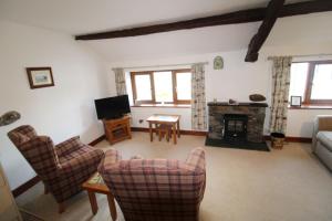 a living room with a couch and a fireplace at Fell View Bassenthwaite in Bassenthwaite