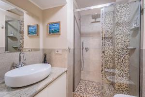 a bathroom with a sink and a shower at Stylish and Perfect Place for Families and Friends in Milan +18 photos