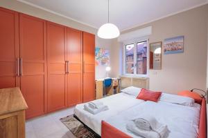 a bedroom with a large bed with orange cabinets at Stylish and Perfect Place for Families and Friends in Milan