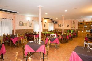 a restaurant with tables and chairs with pink table cloth at Hostal El Rincón - Casa Marcos in Yepes +37 photos