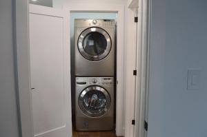 a washer and dryer sitting in a room at Modern East York Retreat 20 mins to DT Toronto in Toronto