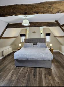 a bedroom with a large bed in a attic at Catton Old Hall Norwich in Norwich