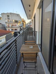 a row of tables and chairs on a balcony at B2 Urban Studio in Larisa