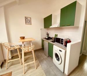 a kitchen with green cabinets and a washing machine at MiCASA, Studio avec Clim hyper centre in Tours +17 photos
