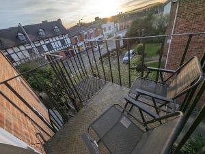 a balcony with a bench and a table and chairs at Shakespeare's Stay in Stratford-upon-Avon