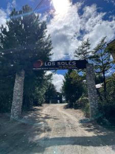 a sign that reads los soules on a dirt road at Cabaña en los soles de montaña in Villa Pehuenia +3 photos