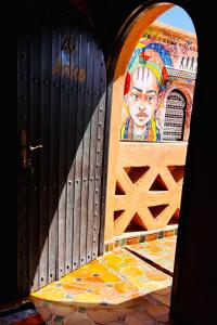 a door with a painting of a man on it at Kasbah Isfoula and Spa in Aït Benhaddou