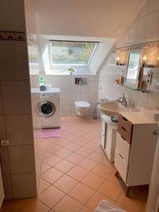 a bathroom with a washing machine and a sink at City View in Bodenwerder