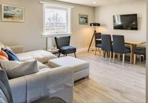 a living room with a couch and a table at 1 North Street, Elie in Elie
