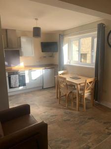 a kitchen and dining room with a table and chairs at Ivy House in Longnor +16 photos