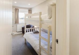 a bedroom with two bunk beds in a room at 1 North Street, Elie in Elie