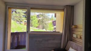 a window in a room with a view of a balcony at Isola 2000 pied des pistes-wifi in Isola