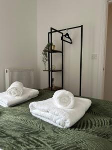 two towels are sitting on top of a bed at No 1 Seafield - Sleeps 5 - Lincoln City in Lincolnshire