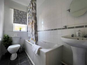 uma casa de banho com uma banheira, um WC e um lavatório. em Station House - 2bed House Central Location em Lincolnshire