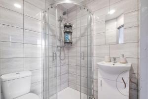 a bathroom with a shower and a toilet and a sink at Gorgeous Longton Studio 2c in Stoke on Trent