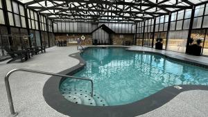 a large swimming pool in a large building at Lazy Bear Den in Sevierville